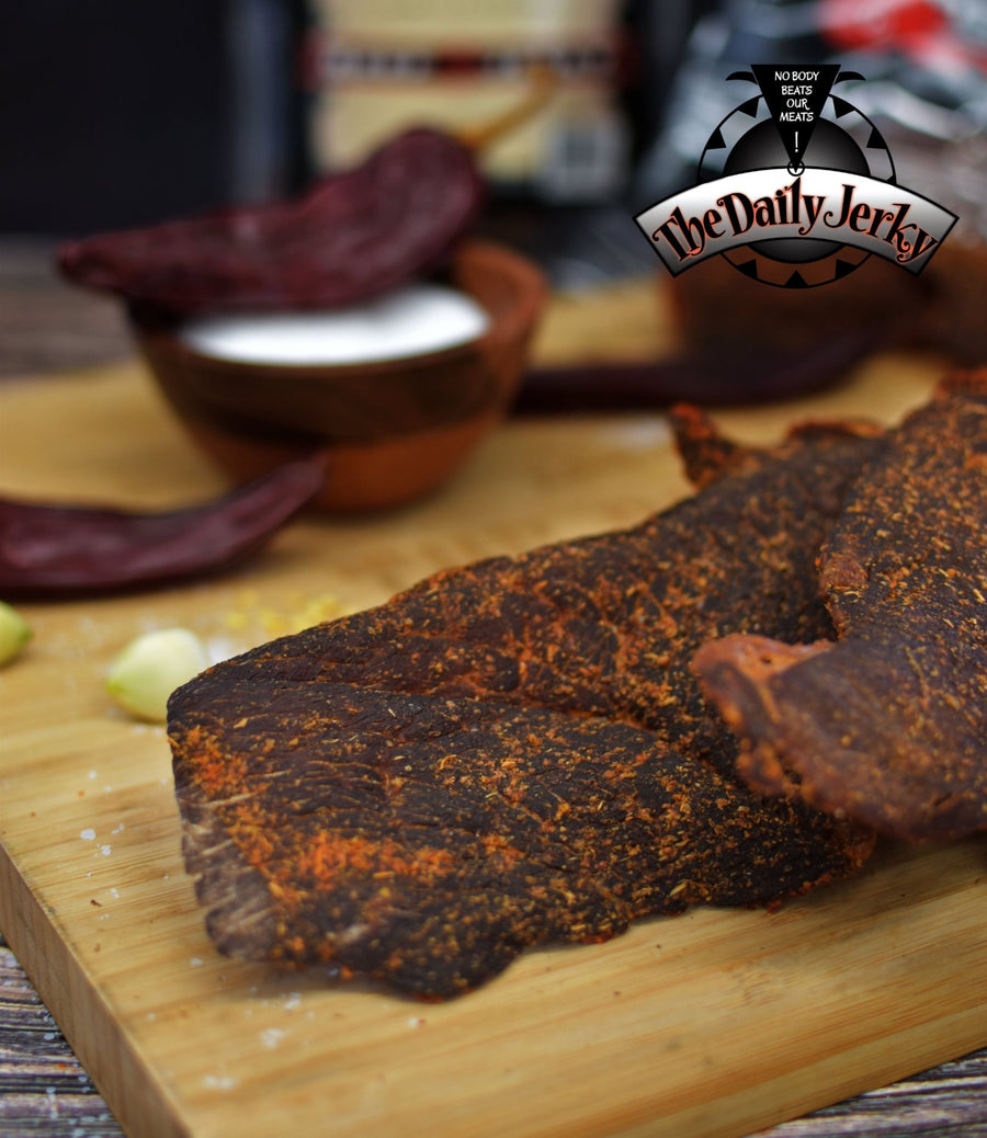 Close up of red chile beef jerky pieces from The Daily Jerky showing dry, seasoned texture