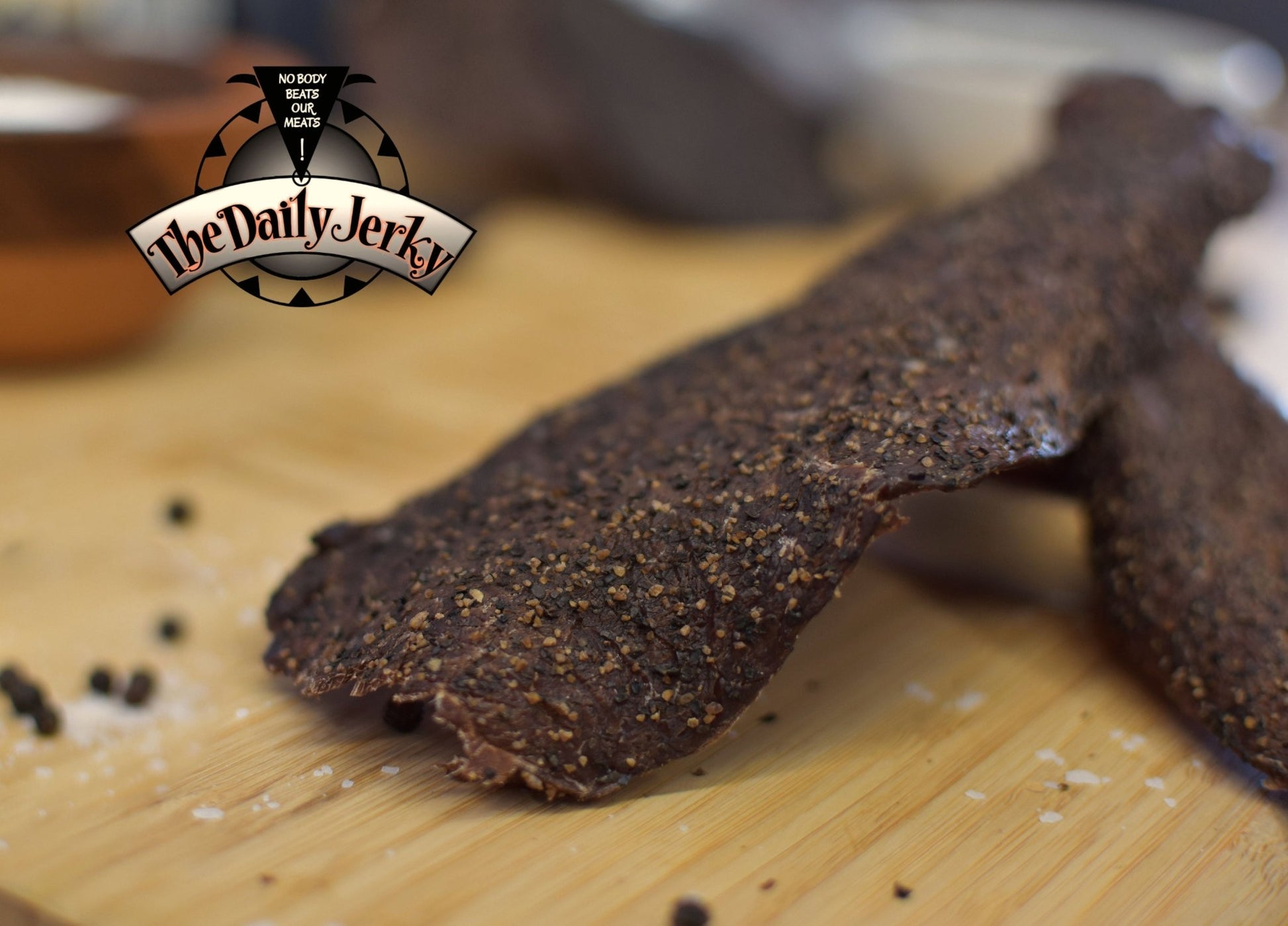 Close up of salt and pepper beef jerky pieces from The Daily Jerky with visible black pepper