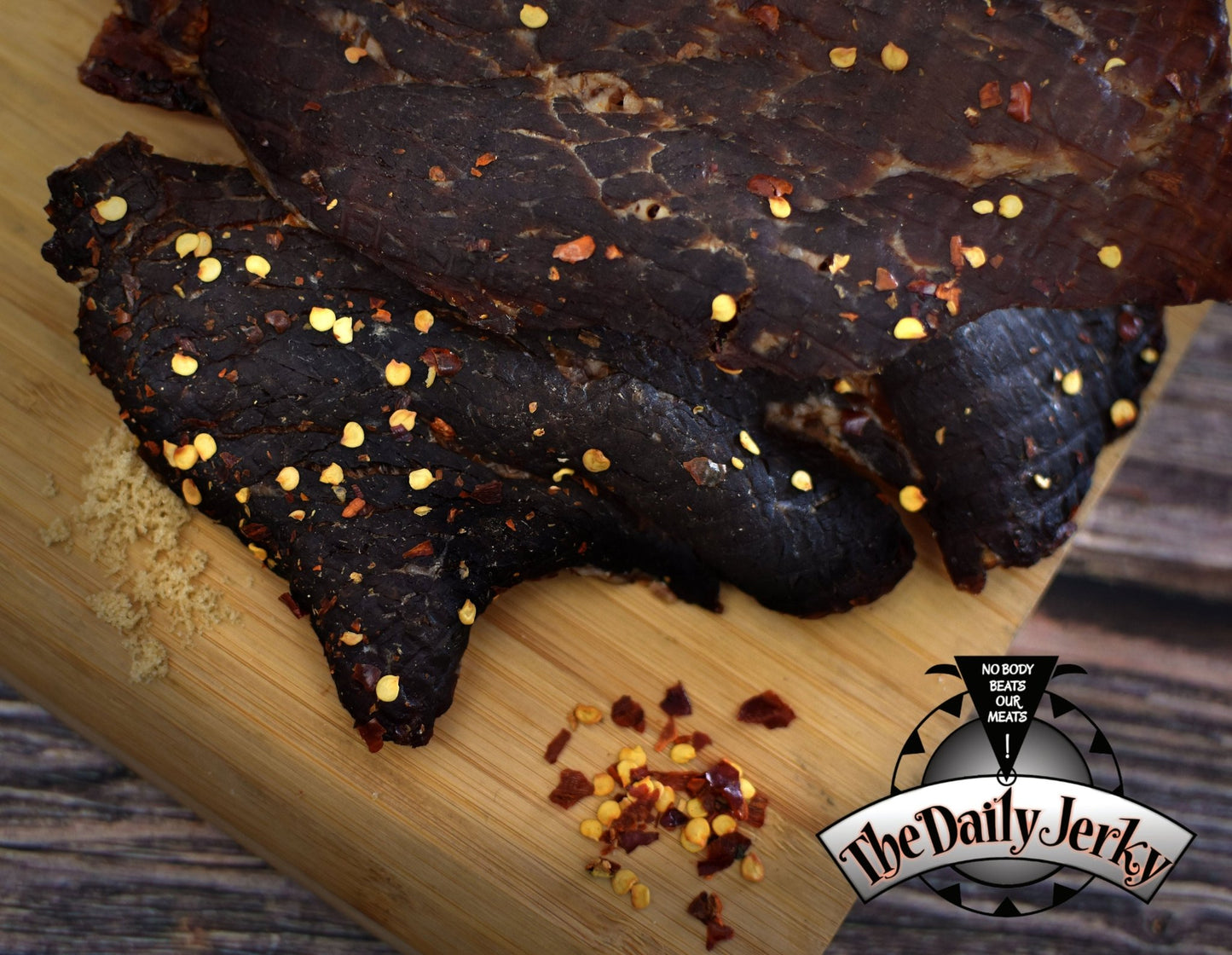 Close up of spicy teriyaki beef jerky pieces from The Daily Jerky showing glossy teriyaki coating