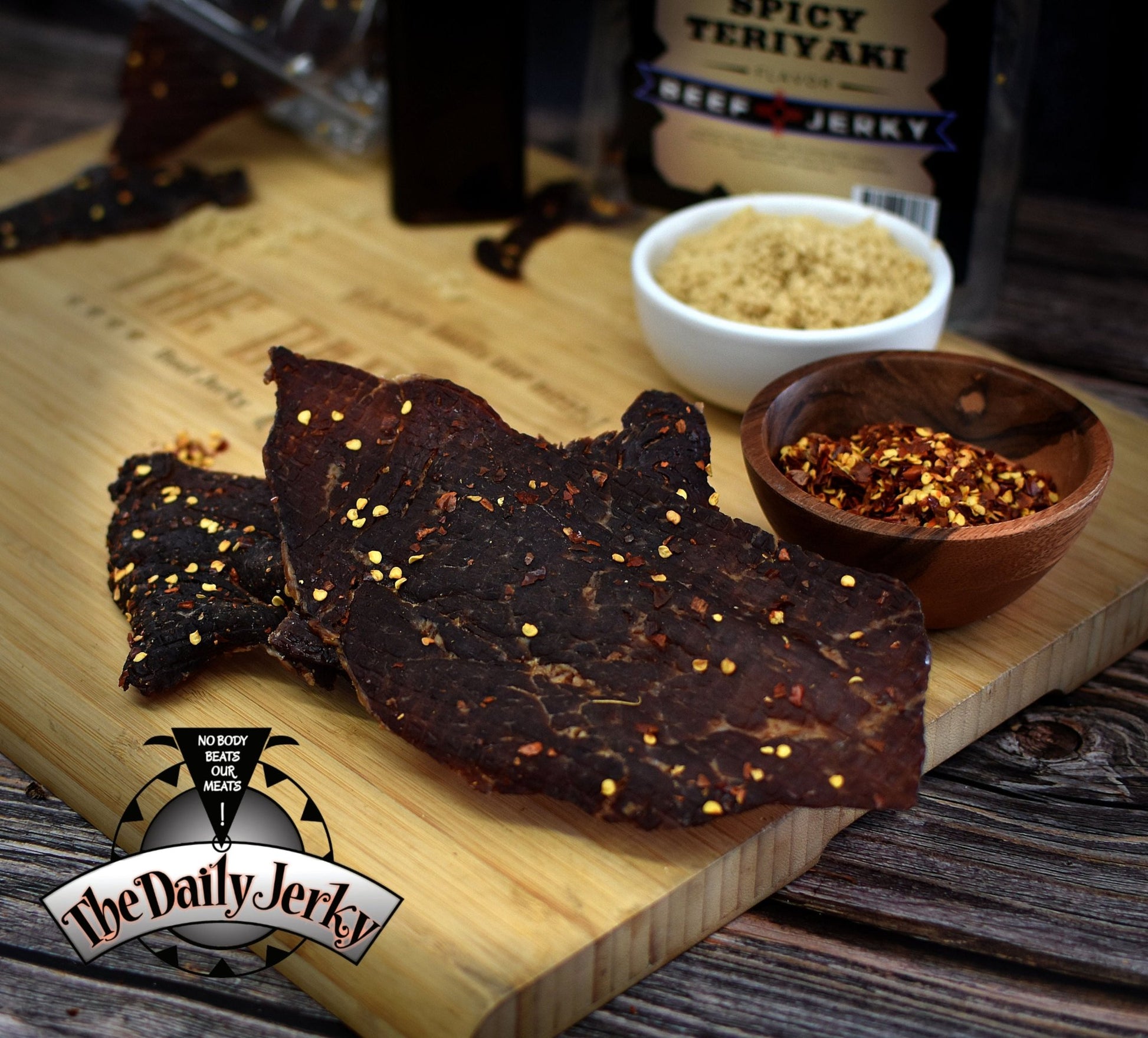 Spicy teriyaki beef jerky from The Daily Jerky in a sweet and spicy flavored bag in the back ground 
