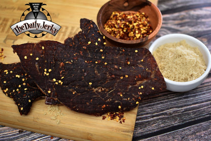 Close up of spicy teriyaki beef jerky pieces from The Daily Jerky showing ingredients in the recipe